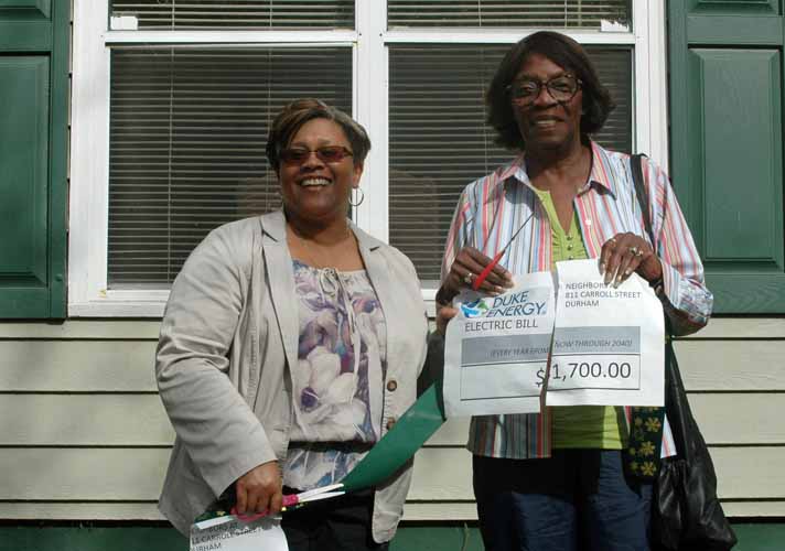 Selina with Brenda, one of the tenants, who has just cut the ribbon as well as her electric bill.